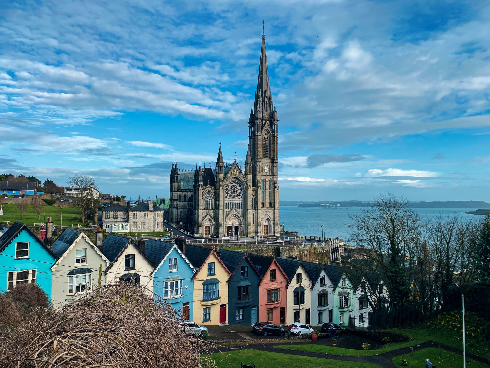 Campingplätze Irland - Stadt mit bunten Häusern und einer Kirche direkt am Meer 